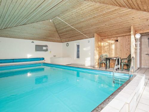 a large swimming pool with a wooden ceiling at 16 person holiday home in Vestervig in Vestervig