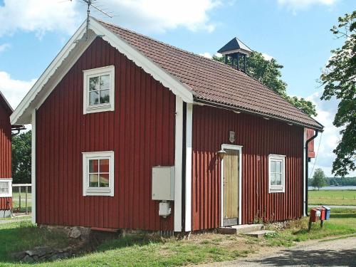 a red barn with a white at 5 person holiday home in LÖNASHULT-By Traum in Torne