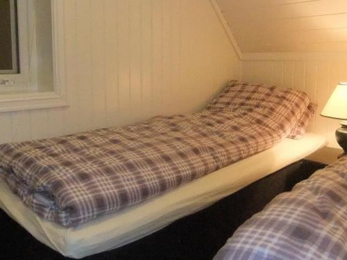 a room with two beds sitting next to a window at 6 person holiday home in Gursken-By Traum in Larsnes