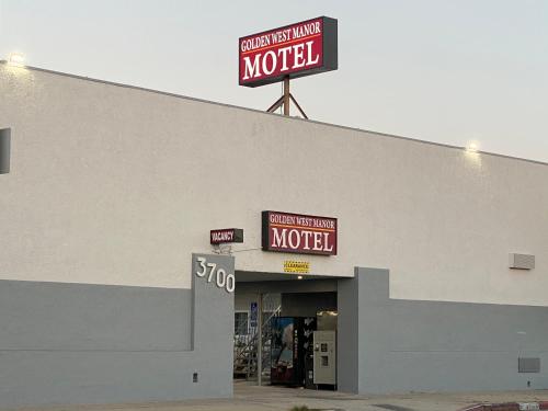 a building with two signs on the top of it at Golden West Manor Motel in Los Angeles