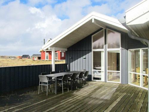 a patio with a table and chairs on a deck at 10 person holiday home in Harbo re in Harboør