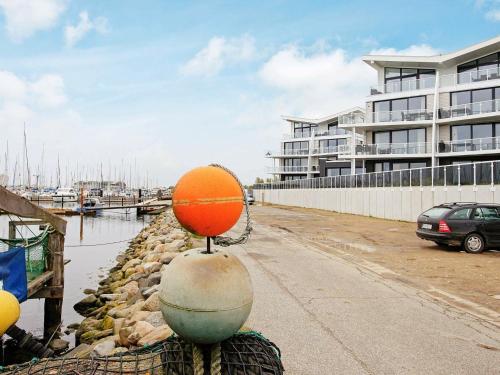 a ball on top of a ball on a wall near a marina at 6 person holiday home in Wendtorf in Wendtorf