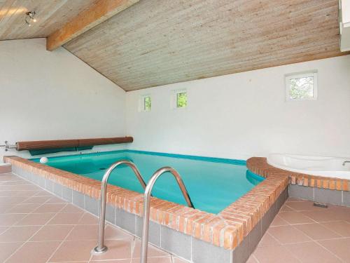 a swimming pool with a tub and a sink at 8 person holiday home in Hj rring in Lønstrup