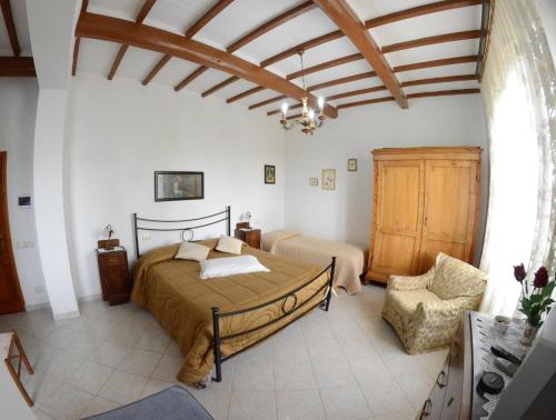 a bedroom with a bed and a chair at Agriturismo Santa Giuditta in Sovicille