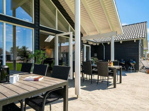 a patio with a table and chairs on a patio at 16 person holiday home in Hasselberg in Kappeln