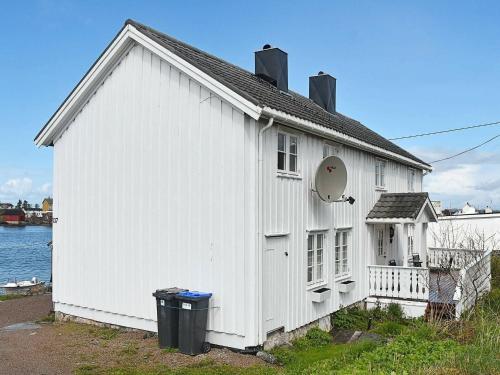 a white building with a large window and a door at 8 person holiday home in averøy in Henda