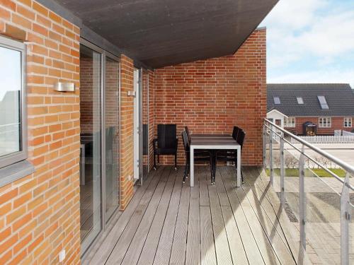 a patio with a table and chairs on a balcony at 8 person holiday home in Hemmet in Hemmet
