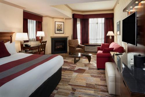a hotel room with a bed and a fireplace at Royal Canadian Lodge in Banff