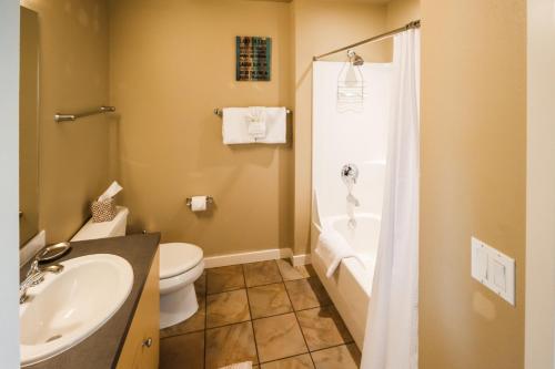 a bathroom with a toilet and a sink and a shower at Chelan Resort Suites 2 in Chelan