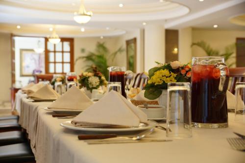a long table with plates and napkins on it at Suites Obelisk in Mexico City