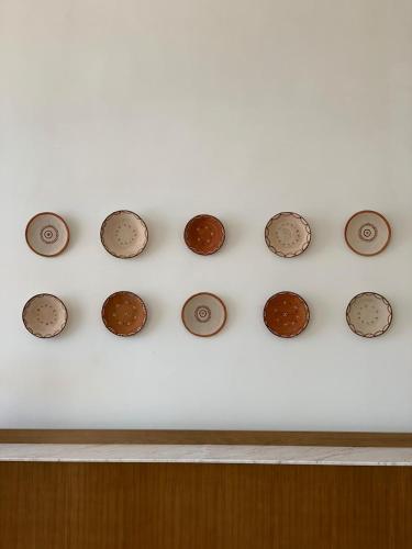 a bunch of coins on a white wall at Marina Smir Hotel & Spa in M'diq