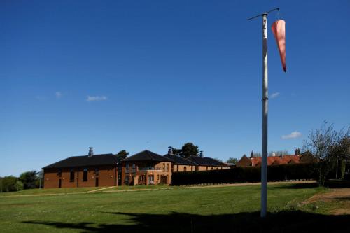 a flag on a pole in front of a house at Knights Hill Hotel & Spa in Kings Lynn