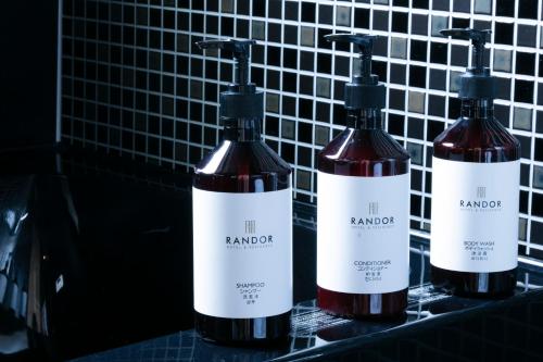 three bottles of wine on a counter in a bathroom at Randor Residential Hotel Fukuoka Annex in Fukuoka