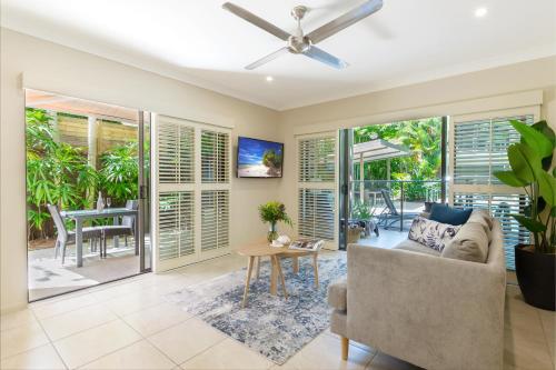a living room filled with furniture and a large window at Shantara Resort Port Douglas - Adults Only Retreat in Port Douglas