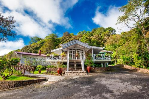 a house on the side of a mountain at Sutera Sanctuary Lodges At Kinabalu Park in Kundasang