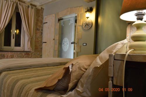 a bedroom with a bed and a clock on the wall at Villa Dacia in Guiglia