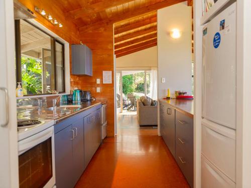 a kitchen with a sink and a counter top at Hahei Hideaway - Hahei Holiday Home in Hahei