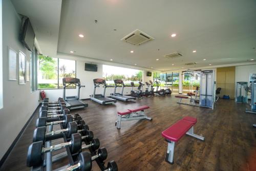 a gym with several treadmills and machines in a room at The Light Hotel Penang in Perai