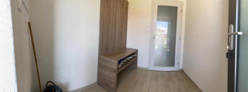 a hallway with a wooden staircase in a house at Apartmán Pod Klinom in Pribylina