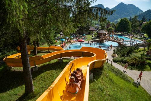a group of people on a slide at a water park at Biobauernhof und Ferienhaus Riederbauer in Rettenschöss