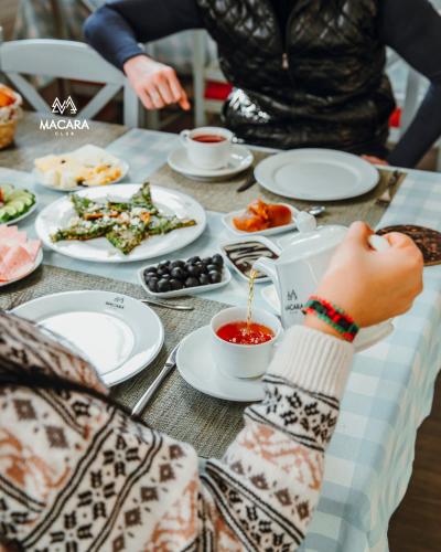 una persona seduta a un tavolo con piatti di cibo di Macara Village Resort a Quba