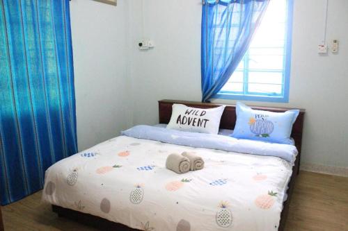 a bedroom with a bed with a hello kitty pillow on it at Coco Country Homes in Melaka