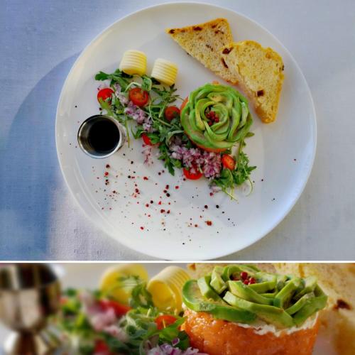 a white plate with a salad and a sandwich and bread at Hotel Kahlberg in Krynica Morska