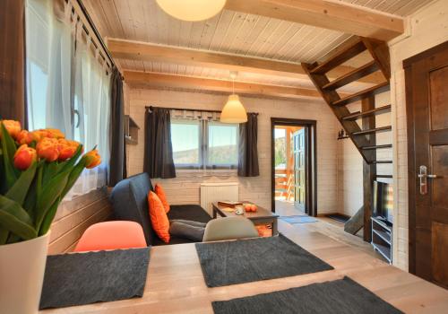 a living room with a couch and a table at Przystanek Krzywe in Cisna