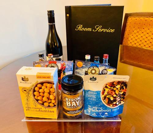 a table with a bottle of wine and a box of food and a bottle at Royal Albert Hotel in Brisbane