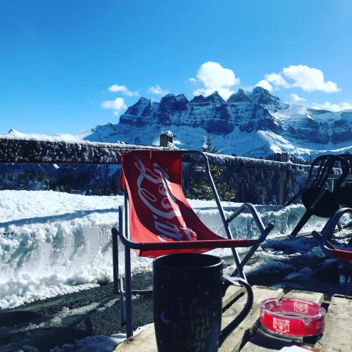 a cocacola chair with a view of mountains at Chez Gaby 1670 in Champoussin