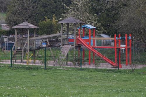 a park with a playground with a slide at Duplex Rue Haute in Laneuveville-derrière-Foug