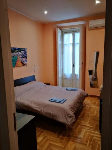 a bedroom with a bed with two towels on it at Casa Cupiello Via Chiaia - Casa Vacanze ad uso Esclusivo in Naples