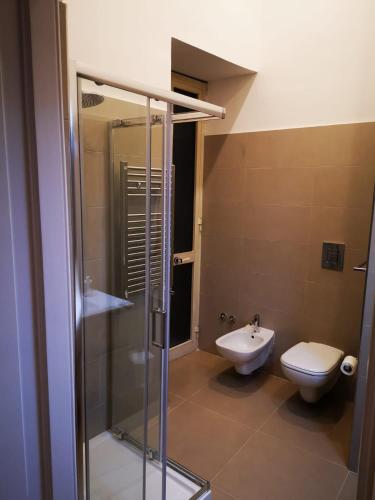 a bathroom with a shower and a toilet and a sink at Casa Cupiello Via Chiaia - Casa Vacanze ad uso Esclusivo in Naples
