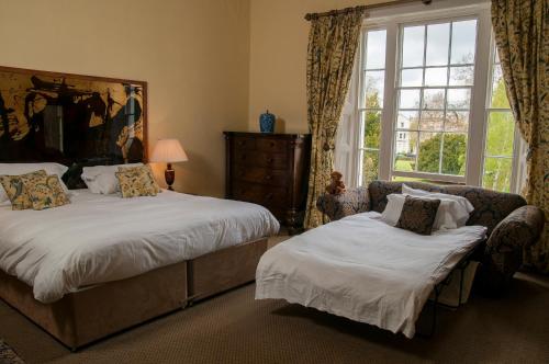 A bed or beds in a room at Clarence Court Hotel