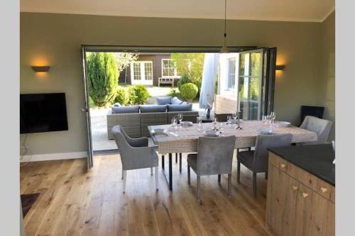 a dining room with a table and chairs at Gartenvilla@Baltic-Chalets in Warnkenhagen