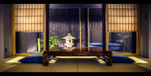 a room with a table in front of a window at TABITABI STAY HIGASHIYAMA in Kyoto