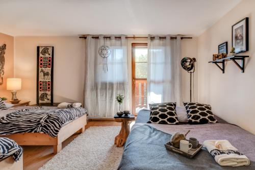 a bedroom with two beds and a window at Africa House in Zlín
