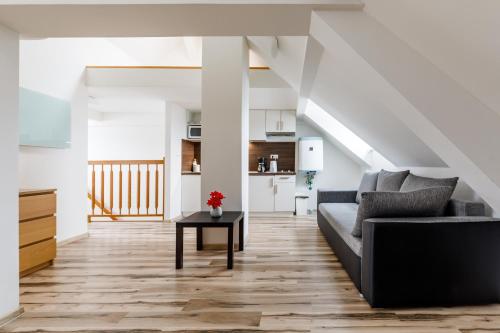 a living room with a couch and a table at Boží Apartments by Mountain ways in Boží Dar