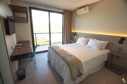 Säng eller sängar i ett rum på NAIM Hotel