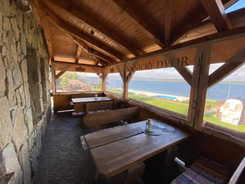 a restaurant with tables and a view of the ocean at Slanický Dvor in Námestovo