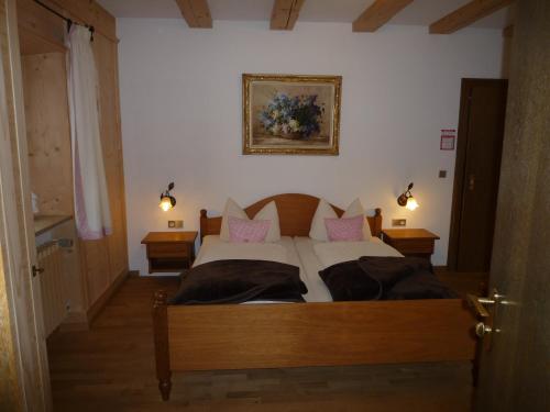 a bedroom with a large bed with pink pillows at Gästehaus Johanna in Bad Wiessee