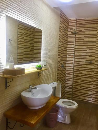 a bathroom with a sink and a toilet at Aparthotel Monterria in Bar