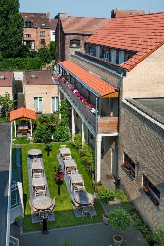 an aerial view of a building with tables and chairs at Parkhotel Gent Centrum in Ghent