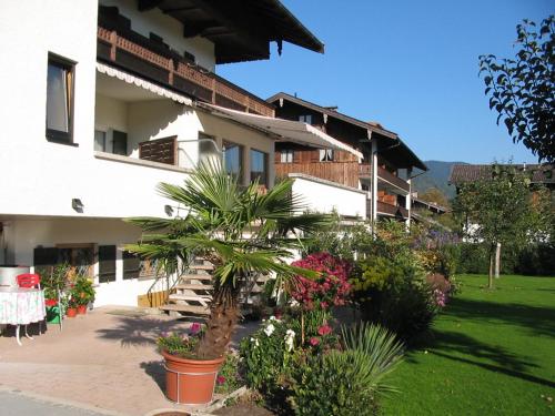 a building with a courtyard with flowers and plants at Gästehaus Johanna in Bad Wiessee