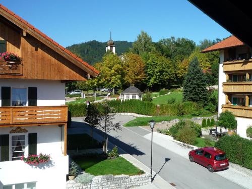 a view of a street in a village with a red van at Gästehaus Johanna in Bad Wiessee