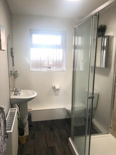 a bathroom with a shower and a sink at Coastal Retreat - Skegness in Skegness