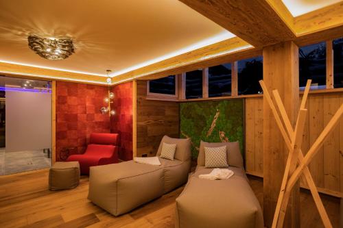 a living room with a couch and a chair at Hotel Garni Berghof in Pertisau