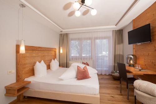 Ένα ή περισσότερα κρεβάτια σε δωμάτιο στο Hotel Garni Berghof