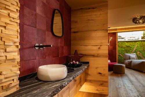 a bathroom with a large bowl sink on a counter at Hotel Garni Berghof in Pertisau