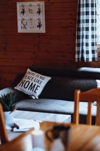 a couch with a pillow that says just for no half life home at Domki u Basi in Kudowa-Zdrój